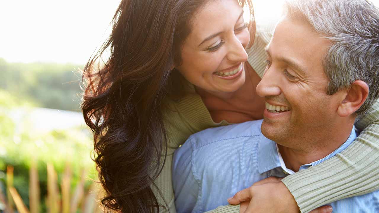 Couple hugging each other on a walk.