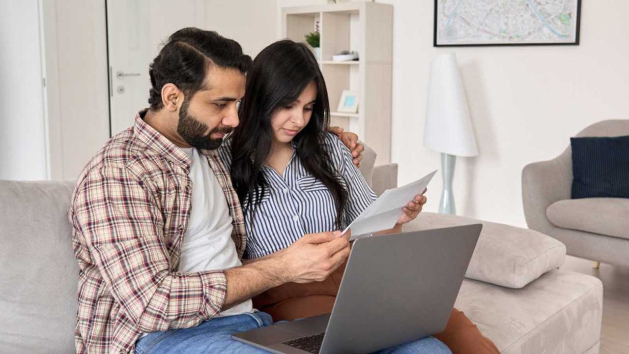 Couple on couch discussing income.