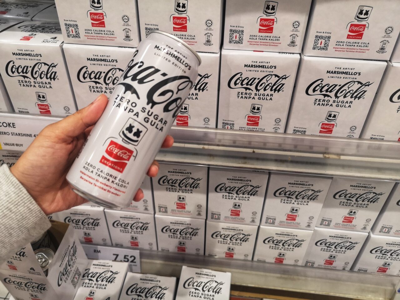 Hand holds up a white can of Marshmellow's limited edition coke zero in Malaysia.