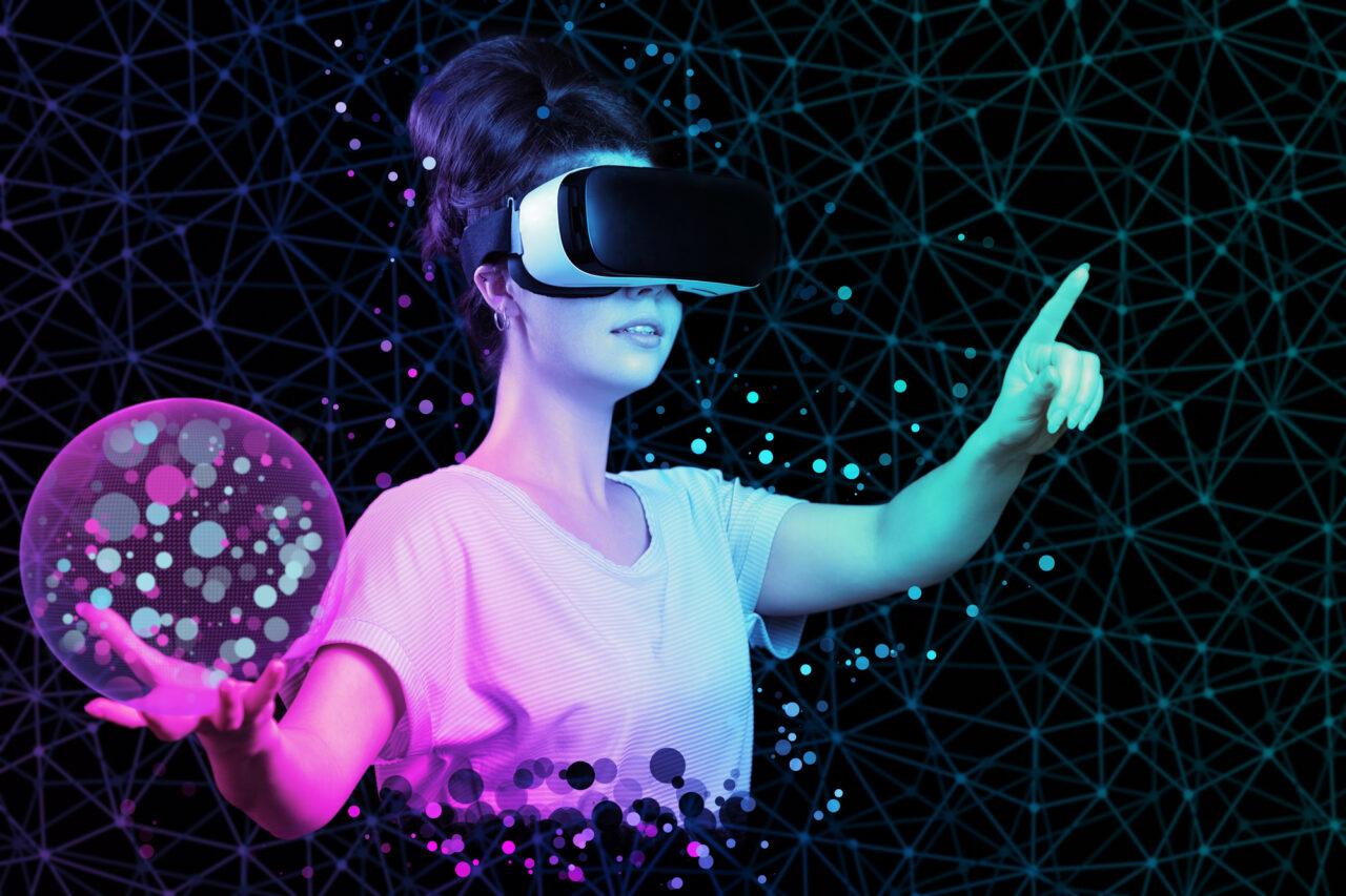 young woman in VR glasses holding 3D simulation of mesh sphere.