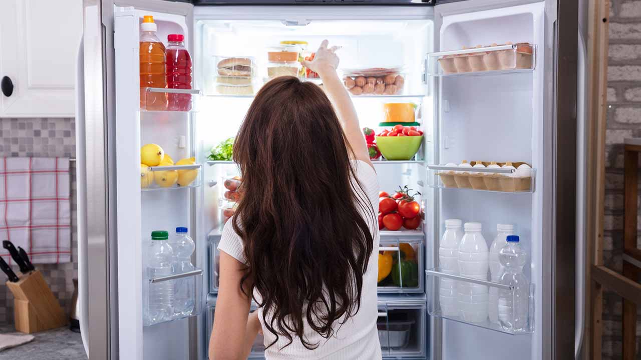 Person organizing the refrigerator