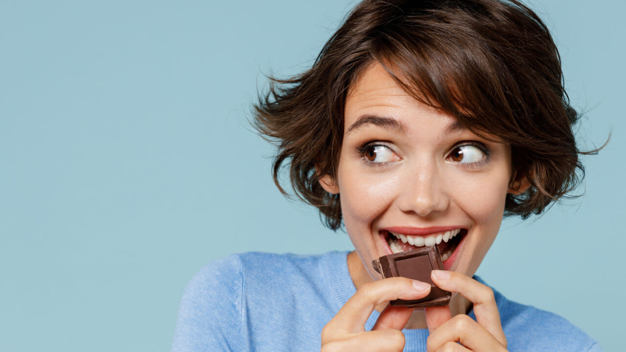 Woman eating chocolate.