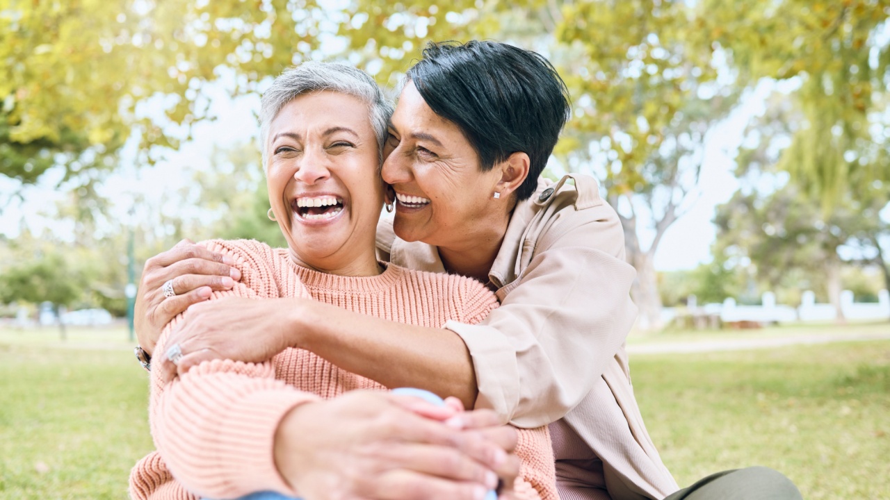 a woman hugging another woman.